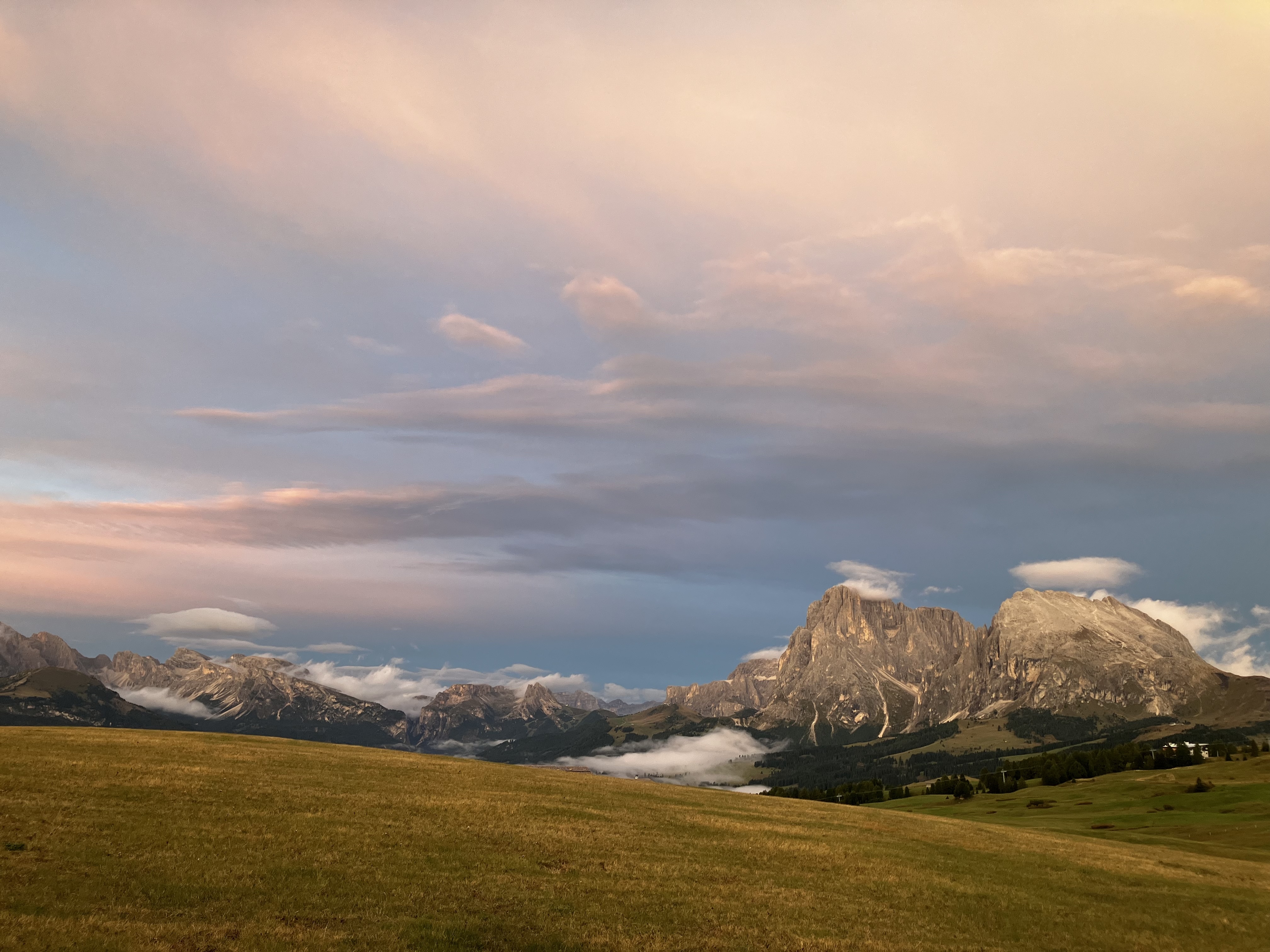 Clouds on top of mountains in Alpi di Siusi
